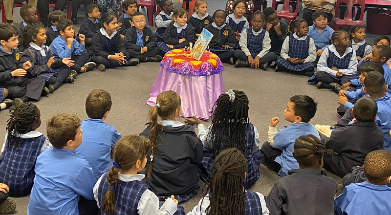 Children sitting around prayer table at Our Lady of the Rosary Catholic Primary School St Marys