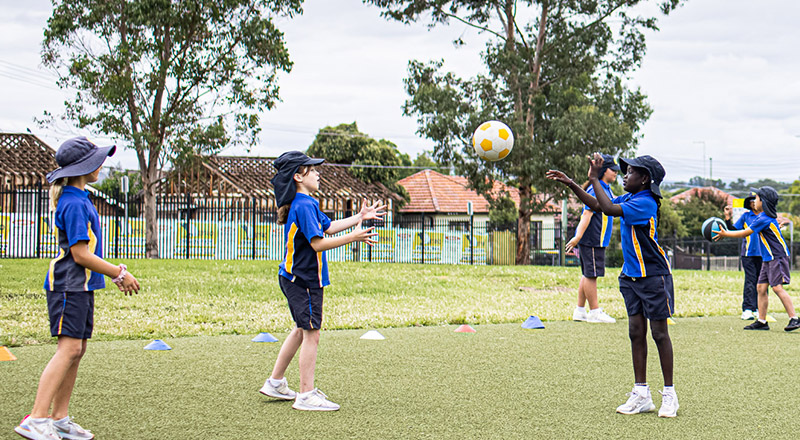 Students throwing ball at Our Lady of the Rosary Catholic Primary School St Marys