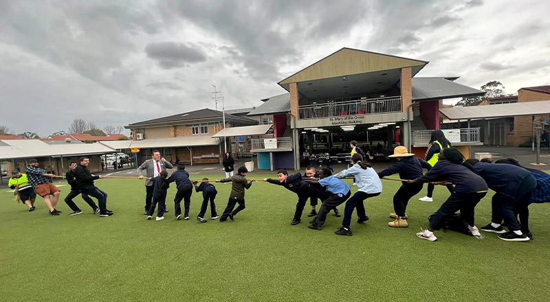 Parents and students playing tug-of-war at Our Lady of the Rosary Catholic Primary School St Marys