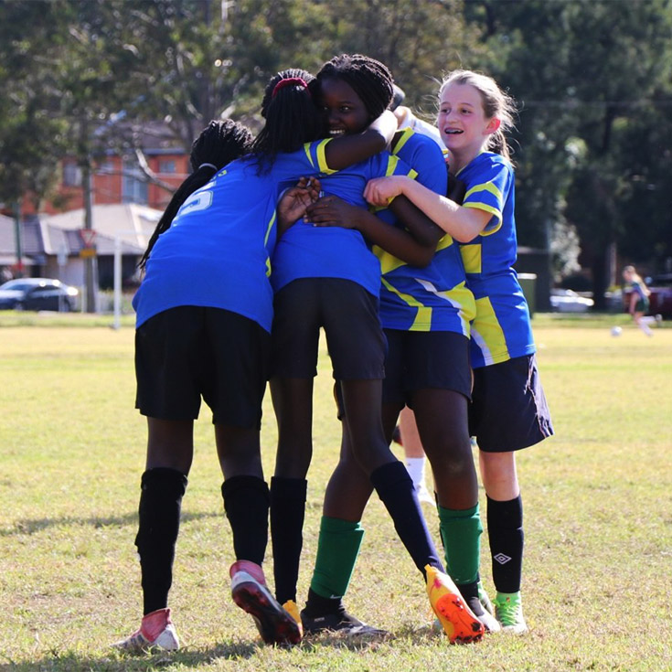 Students from Our Lady of the Rosary Catholic Primary School St Marys hugging after a soccer game