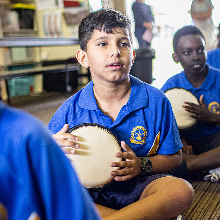 Student playing bongo drums at Our Lady of the Rosary Catholic Primary School St Marys