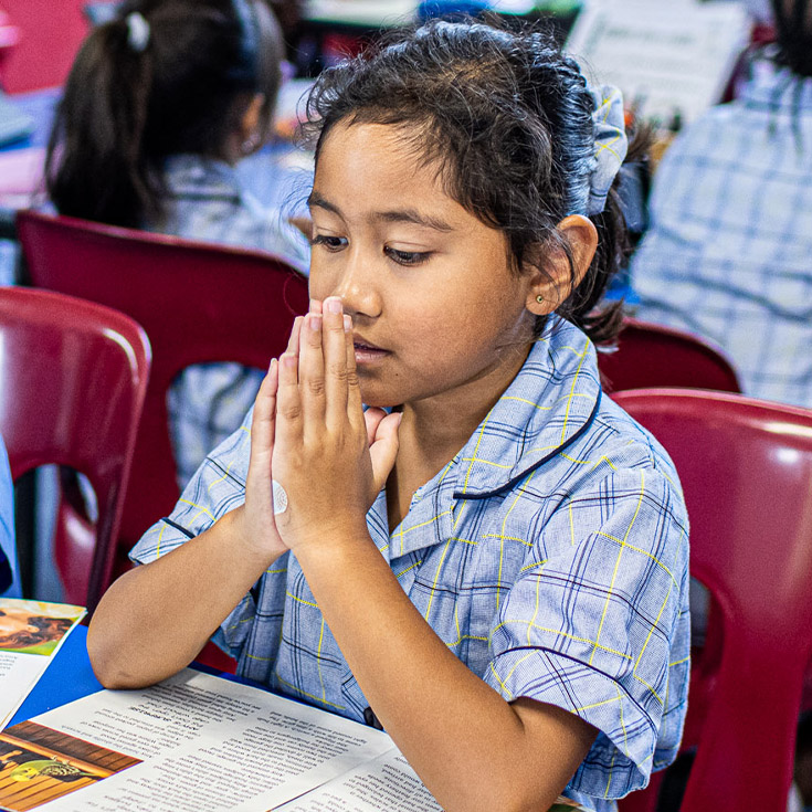 Student praying at Our Lady of the Rosary Catholic Primary School St Marys